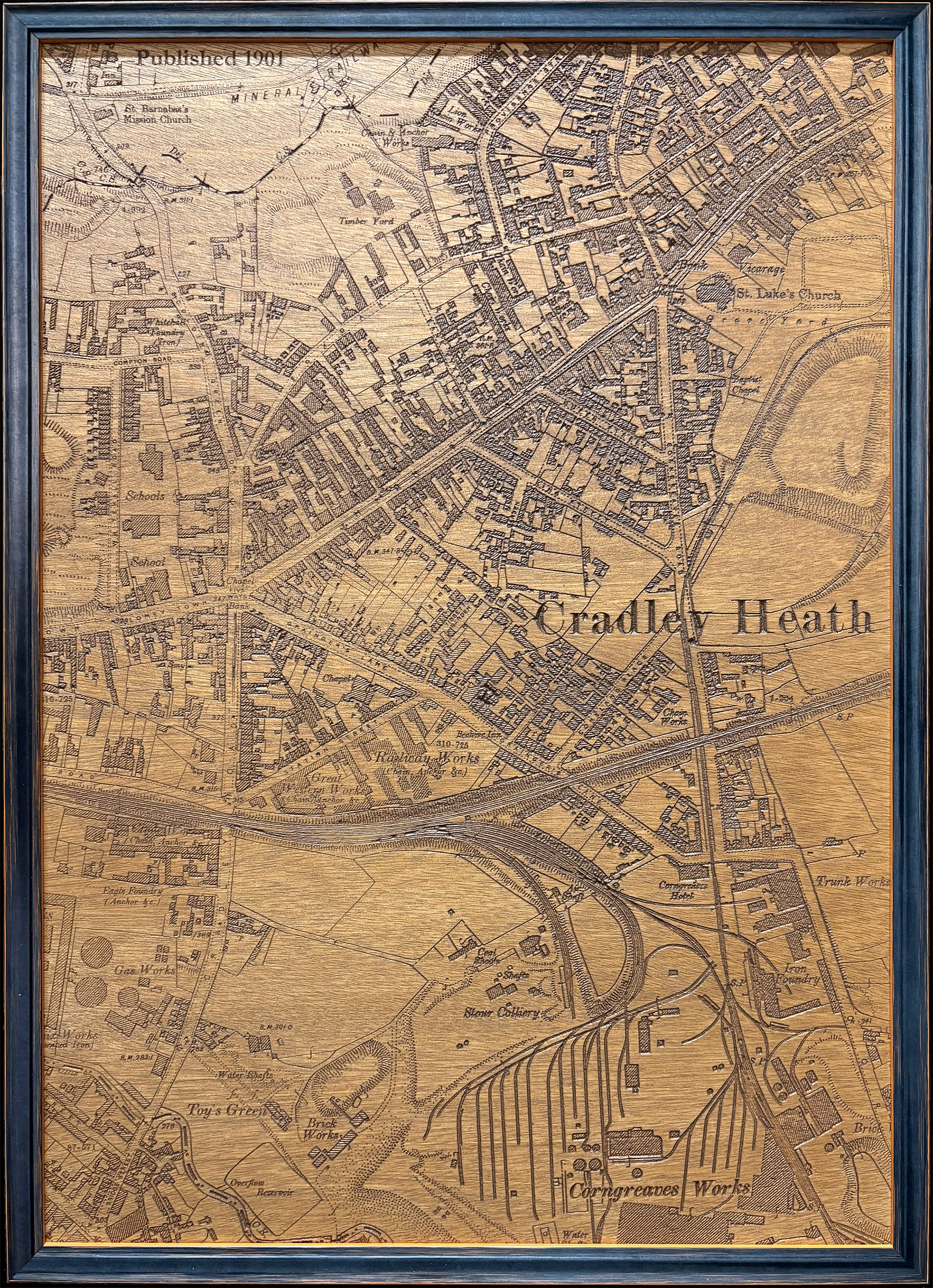 A framed CNC-carved wooden map carved in hardwood using a CNC machine from a historical cartographic map, ready to hang wall art.